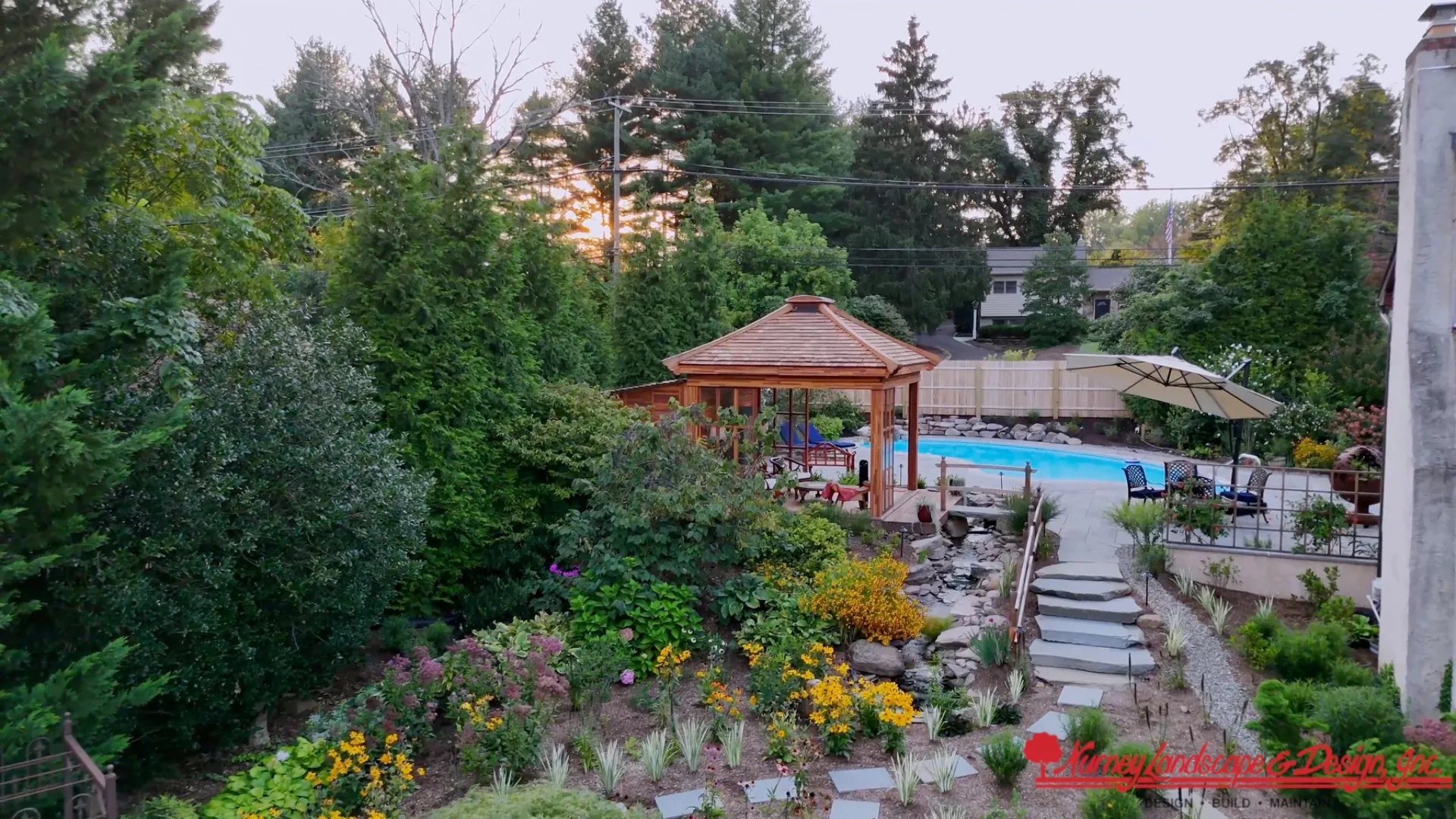 Finished residential garden with colorful planting, walkways and a pool