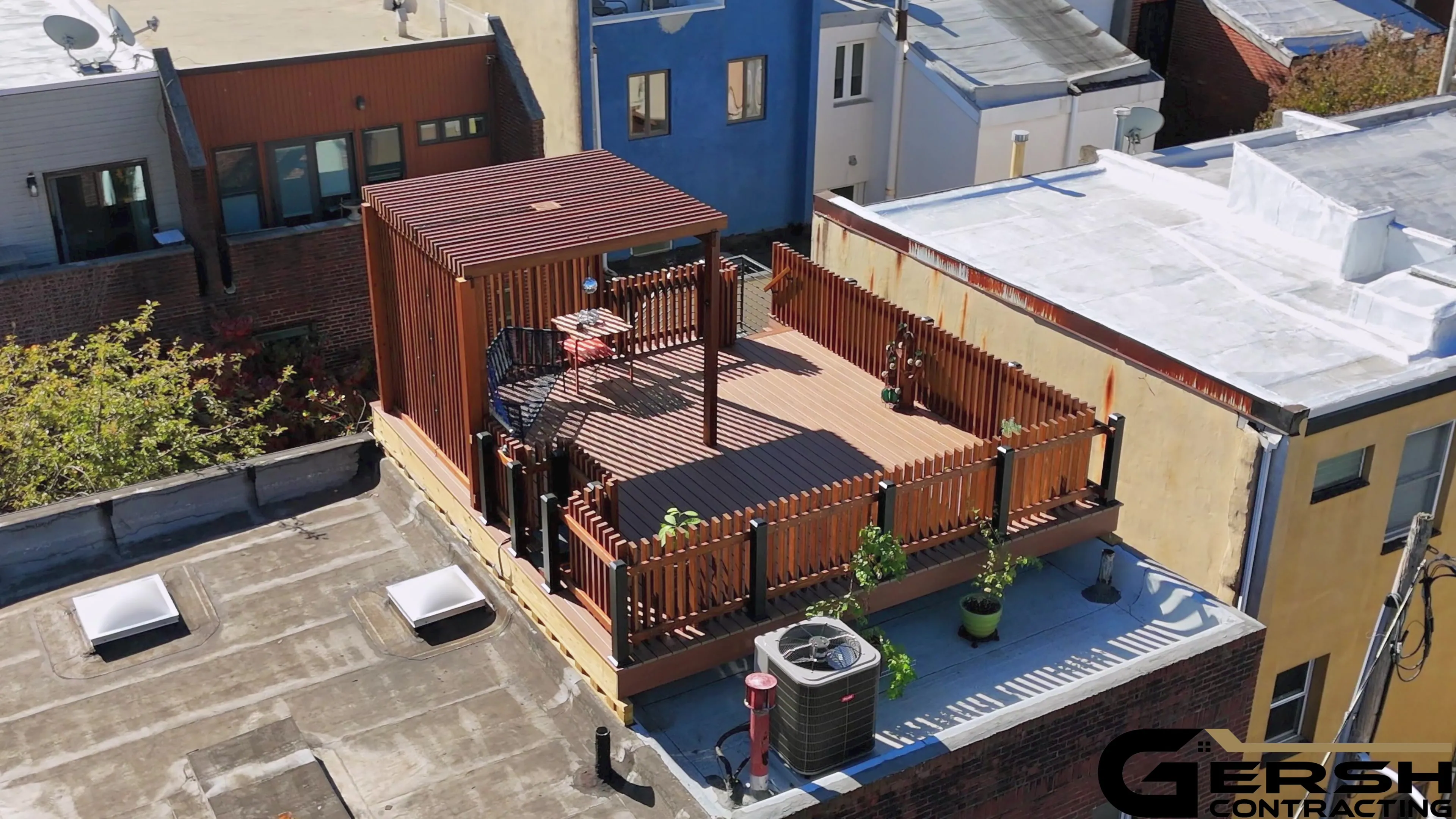 Aerial view of a finished rooftop deck and its surrounding architecture